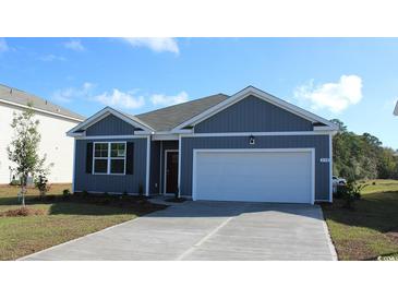 Charming home featuring a gray exterior, two-car garage, and well-maintained landscaping at 514 Sagebrush St., Myrtle Beach, SC 29588