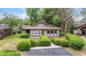 Charming single-story home featuring manicured shrubs and a well-maintained front yard at 931 Cedarwood Circle, Myrtle Beach, SC 29572