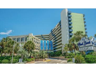 Attractive view of the Coral Beach Resort with its lush landscaping and blue accents at 1105 S Ocean Blvd. # 420, Myrtle Beach, SC 29577