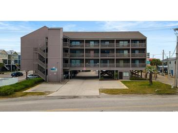 Exterior view of a multi-story condo with ground-level parking and easy access to nearby attractions at 120 Dogwood Dr. N # 209, Murrells Inlet, SC 29576