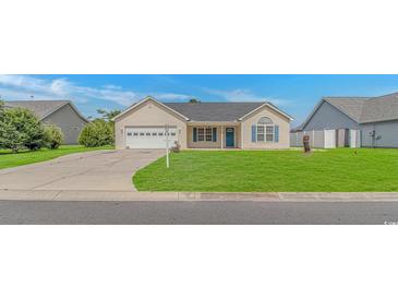 Charming single-story home with a well-manicured lawn and attached two car garage at 125 Balsa Dr., Longs, SC 29568