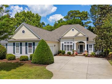 Charming single-story home with beige siding, mature landscaping, and a spacious concrete driveway at 190 Barony Pl., Pawleys Island, SC 29585