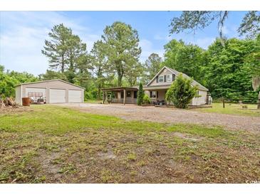 Charming home with a detached garage and a spacious yard, perfect for outdoor activities at 2776 Holly Rd., Marion, SC 29571