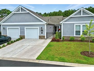 Charming home featuring a two-car garage, manicured lawn, and inviting facade at 4027 Taranto Loop # C, Myrtle Beach, SC 29579
