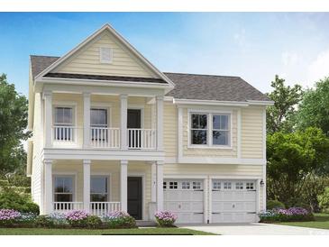 Charming two-story home boasts a welcoming double porch, complemented by a two-car garage and manicured landscaping at 477 Magnolia Terrace Dr, Myrtle Beach, SC 29579