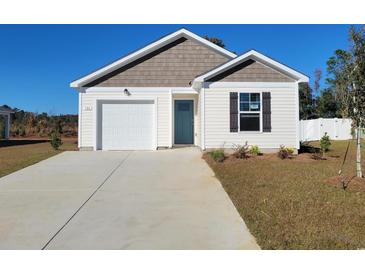 Charming one-story home with a well-maintained lawn and an attached garage, offering comfortable suburban living at 1009 Garden Sprout Dr, Galivants Ferry, SC 29544