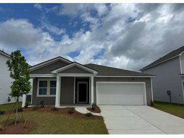 Charming single-Gathering home featuring a two-car garage and manicured front yard at 1014 Laconic Dr., Myrtle Beach, SC 29588
