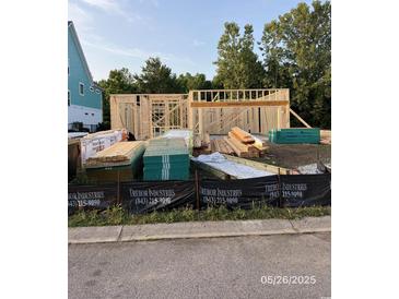 Framing of a new home under construction, showcasing the initial structure and design layout at 124 Palmetto Harbour Dr., North Myrtle Beach, SC 29582