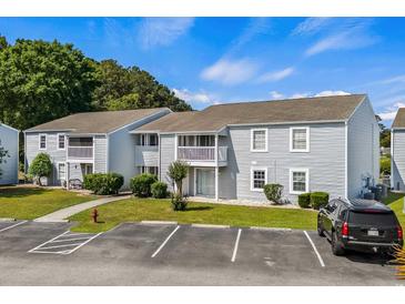 Charming condo building featuring a maintained lawn and adjacent parking for easy access at 1356 Glenns Bay Rd. # 202H, Myrtle Beach, SC 29575