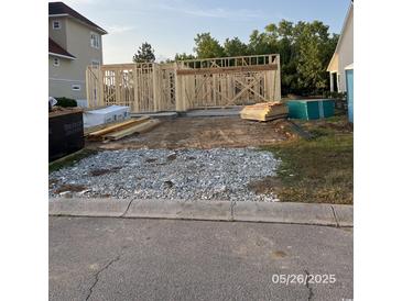 New home construction with wood frame on a sunny day, awaiting further development at 140 Palmetto Harbour Dr., North Myrtle Beach, SC 29582