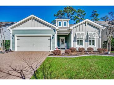 Charming single-Gathering home with a well-maintained lawn, two car garage, and welcoming front porch at 1903 Francis Ct., Myrtle Beach, SC 29577