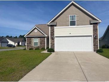 Charming home featuring a two-car garage, stone accents, and well-maintained landscaping at 224 Fishburn Dr., Conway, SC 29526
