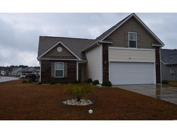 Charming single-Gathering home featuring a two-car garage, landscaped front yard, and a mix of brick and vinyl siding at 224 Fishburn Dr., Conway, SC 29526