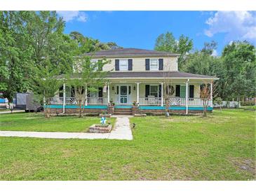 Charming two-story home with a large front porch, blue accents, and a well-manicured lawn at 238 Robin Dr., Georgetown, SC 29440