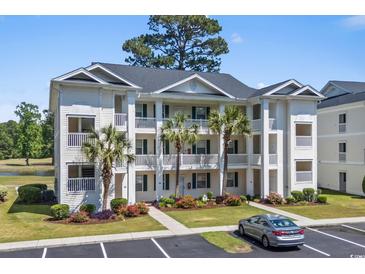 Three-story condo building featuring private balconies, lush landscaping, and convenient parking at 650 River Oaks Dr. # 46I, Myrtle Beach, SC 29579