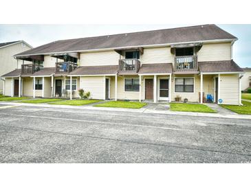 Two-story condo building featuring balconies, vinyl siding, and well-maintained green spaces at 755 Burcale Rd. # D6, Myrtle Beach, SC 29579
