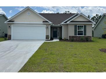 Charming single Gathering home with a two car garage, stone accents, and manicured lawn at 918 Padgett Lane, Conway, SC 29526