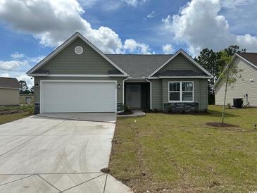 Charming single-story home featuring a two-car garage and manicured front lawn at 934 Padgett Lane, Conway, SC 29526