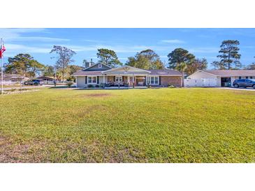 Charming single-story home with a spacious front yard and inviting covered porch at 1014 Thomas Ave., North Myrtle Beach, SC 29582
