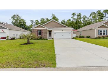 Charming single-story home featuring a well-manicured lawn, concrete driveway, and an attached two-car garage at 252 Legends Village Loop, Myrtle Beach, SC 29579