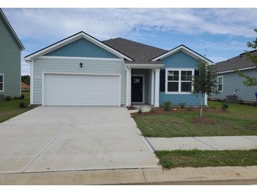 Charming single-Gathering home with a one-car garage, beautiful light blue siding, and a well-manicured lawn at 2702 Riverboat Way, Conway, SC 29526