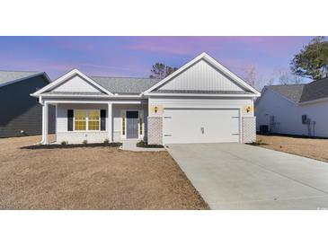 Charming single-story home with a two-car garage and well-maintained landscaping at 618 Lightwood Dr., Conway, SC 29526