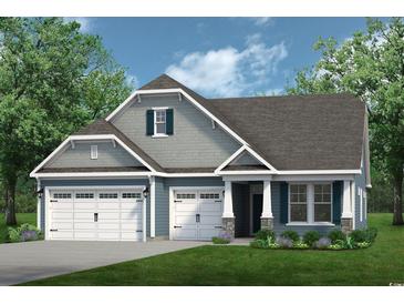 Charming home featuring a three-car garage, gray siding, stone accents, and well-manicured lawn at 711 St. Vincent Loop, Little River, SC 29566