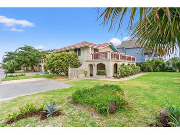 Charming mediterranean-style home featuring lush landscaping and a beautiful brick facade at 807 N Waccamaw Dr., Murrells Inlet, SC 29576