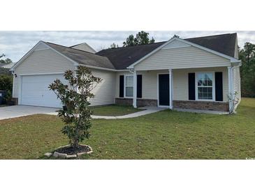 Charming single-story home featuring a well-maintained lawn and attached garage at 962 Willow Bend Dr., Myrtle Beach, SC 29579