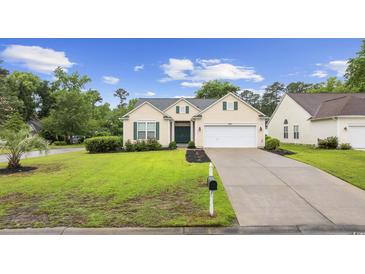 Charming single-story home with a well-manicured lawn, black mulch, and an attached garage at 9831 Winchester Ct., Murrells Inlet, SC 29576