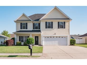 Charming two-story home featuring a well-maintained lawn and a two-car attached garage at 1031 Snowberry Dr., Longs, SC 29568
