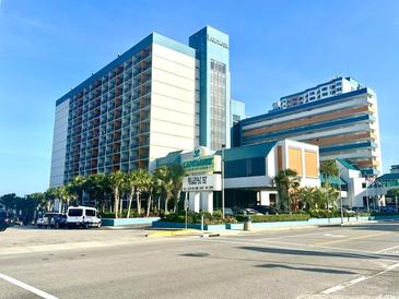 Oceanfront resort featuring palm trees, blue accents, and a well-maintained landscape at 1501 S Ocean Blvd. # 1112, Myrtle Beach, SC 29577