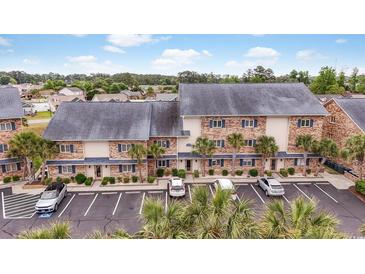 Beautiful condo complex with palm trees and ample parking spaces for residents and visitors at 207 Double Eagle Dr. # F-3, Myrtle Beach, SC 29575