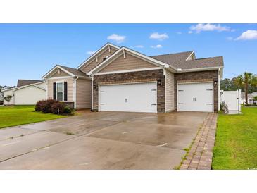 Beautiful home with a two car garage, stone accents, and well-maintained landscaping at 2317 Myerlee Dr., Myrtle Beach, SC 29588