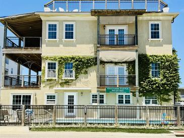Charming, multi-story home with lush greenery, multiple balconies, and covered decks, creating a serene outdoor living space at 3709 N Ocean Blvd., North Myrtle Beach, SC 29582