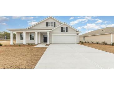 Charming one-story home with a well-manicured lawn and a spacious two-car garage, creating a welcoming curb appeal at 4458 East Coast Ln., Shallotte, NC 28470