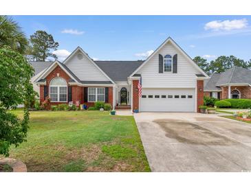 Charming single-Gathering home with a brick and vinyl exterior, complemented by a well-manicured lawn at 4818 Harvest Dr., Myrtle Beach, SC 29579