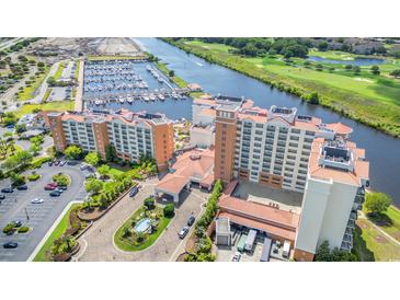 Stunning aerial view of waterfront resort, marina, and golf course, offering luxurious amenities and scenic surroundings at 8121 Amalfi Pl. # 7-604, Myrtle Beach, SC 29572