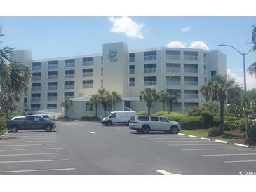 Condo exterior with parking lot and neatly landscaped grounds showcasing beachside living at 9400 Shore Dr. # 507, Myrtle Beach, SC 29572