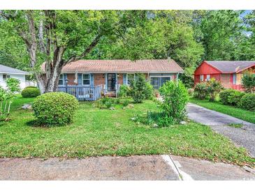 Charming single-story home with a well-maintained lawn and mature trees providing shade and curb appeal at 1104 Ragin St., Myrtle Beach, SC 29577