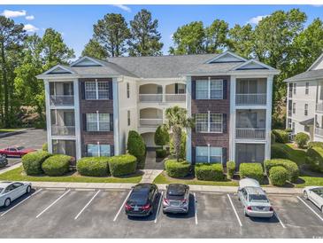 Beautiful condo with brick facade, screened porches, mature landscaping, and ample parking at 1290 River Oaks Dr. # 7H, Myrtle Beach, SC 29579