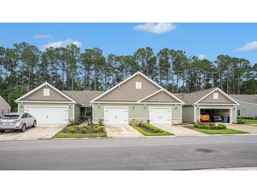 Charming townhomes featuring attached garages and meticulously landscaped front yards at 2016 Willow Run Dr. # B, Little River, SC 29566