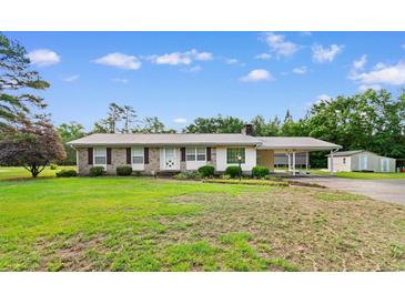 Charming single-story home with a metal roof, brick accents and a covered carport at 2096 Golden Leaf Rd., Galivants Ferry, SC 29544