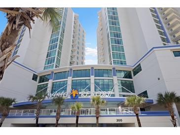 Beautiful Avista Resort entrance view with palm trees and bright blue sky in North Myrtle Beach at 304 North Ocean Blvd. # 506, North Myrtle Beach, SC 29582