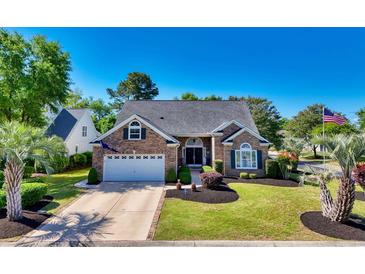 Charming single-story brick home with an attached garage, manicured lawn, and mature landscaping at 4 Stillwater Ct., Murrells Inlet, SC 29576