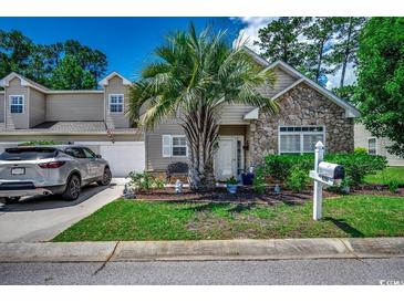 Charming home with stone accents, a landscaped yard, and a welcoming entrance with a palm tree at 4294 Rivergate Ln., Little River, SC 29566