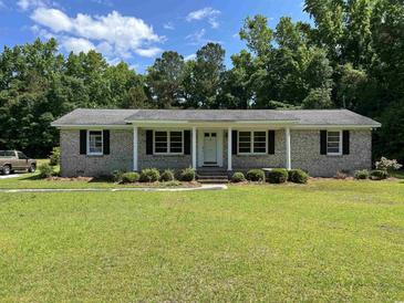 Charming brick home featuring a well-manicured front yard and a inviting entryway at 444 Davis Rd., Hemingway, SC 29554
