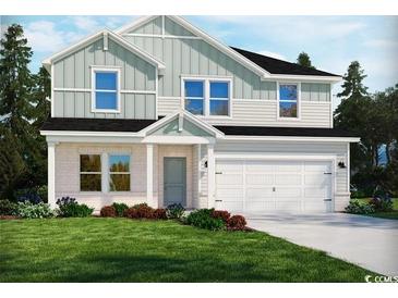 Charming two-story home featuring a large front yard, a two-car garage, and eye-catching architectural details at 4861 Hopespring St., Myrtle Beach, SC 29579