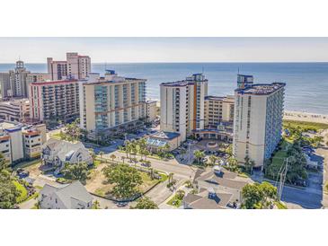 Beautiful aerial view of a beachfront hotel property with ocean views and palm trees at 5300 N Ocean Blvd. N # 1120, Myrtle Beach, SC 29577