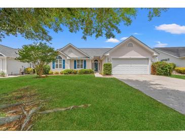 Charming single-story home featuring manicured lawn, blue shutters, and an attached two-car garage at 535 Wildflower Trail, Myrtle Beach, SC 29579